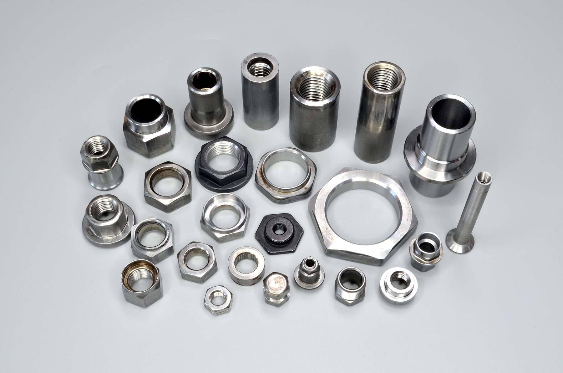 Lien Ya hex nuts, flange nuts and internally threaded turned components on a light background